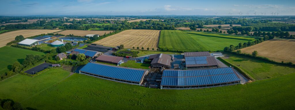Solar panels for farms, large farmland with panels on roofs.